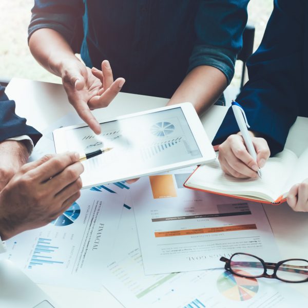 Asian business adviser meeting to analyze and discuss the situation on the financial report in the meeting room.Investment Consultant,Financial Consultant,Financial advisor and accounting concept